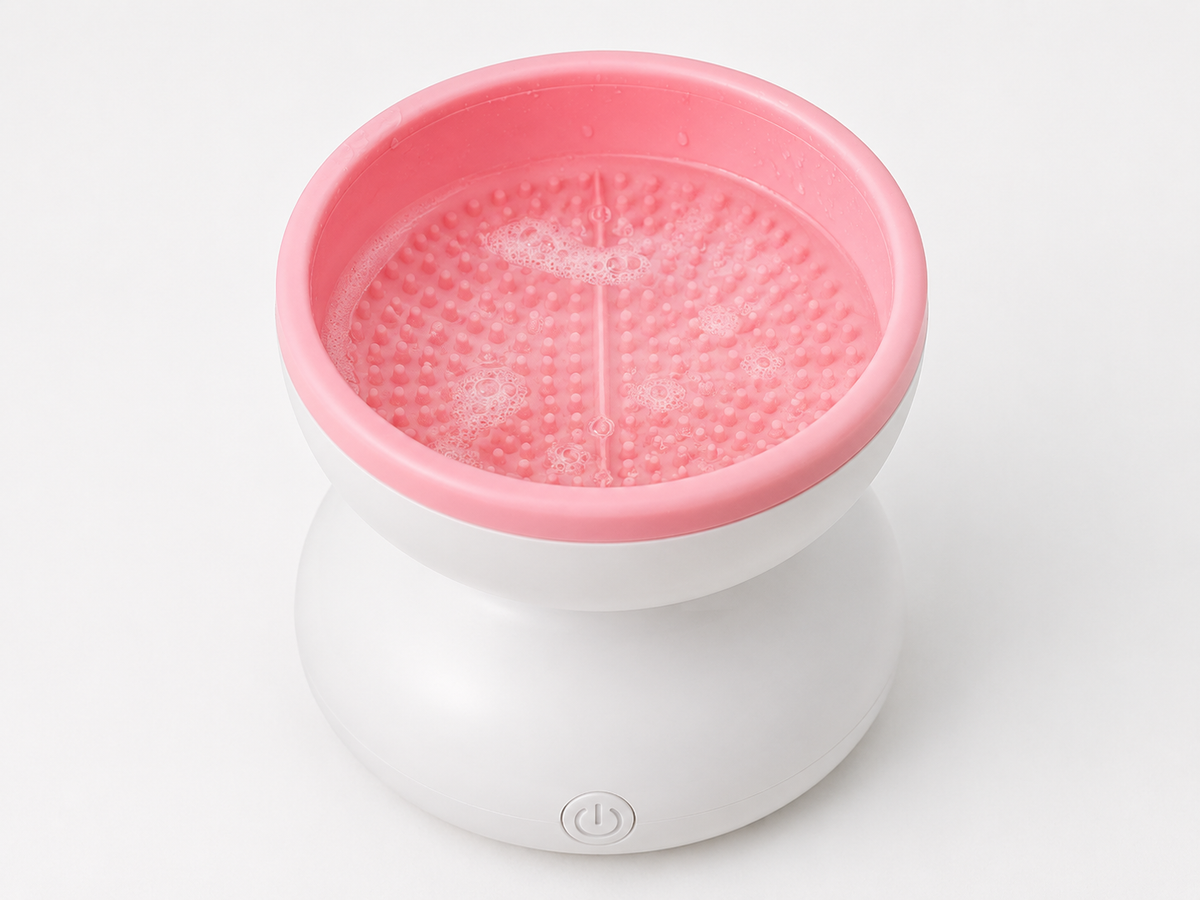Filling the Electric Makeup Brush Cleaner container with water and cleanser